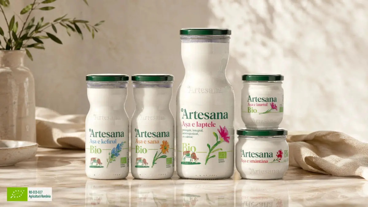 Produse lactate Bio Certificate Ecologic Artesana - kefir, sana, lapte si smantana Bio in borcanele si sticlele lor pe un fundal crem, insorit si linistitor